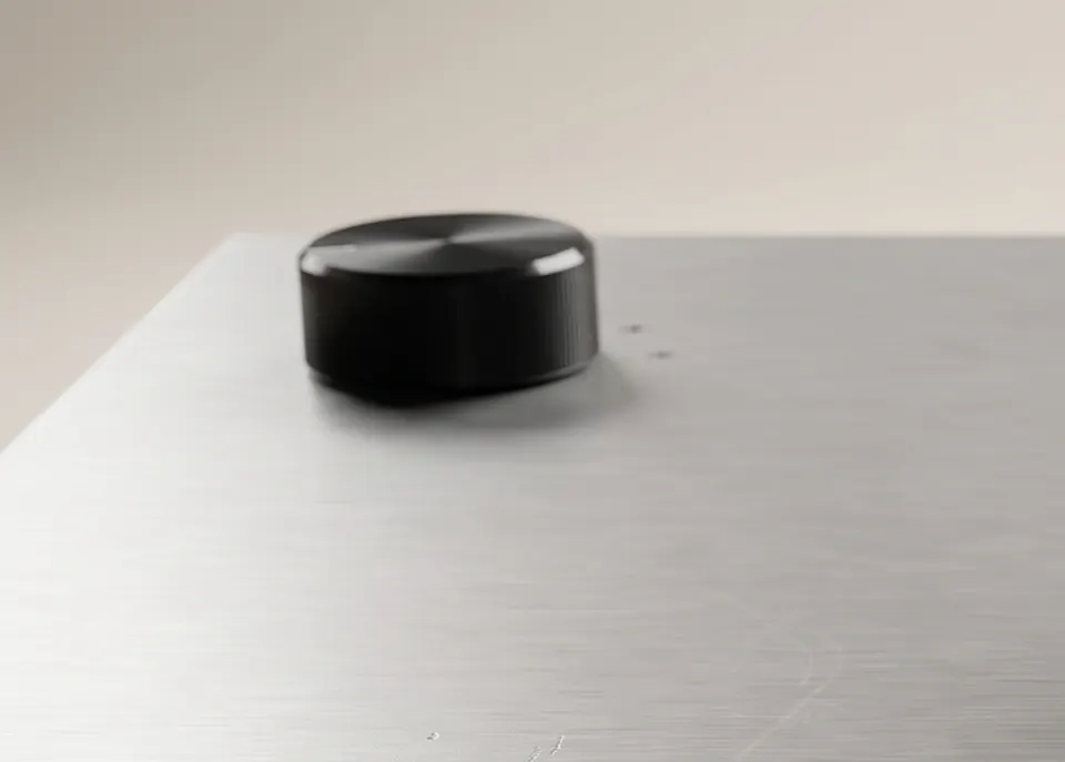 A control knob on a brushed-aluminium plinth, close up
